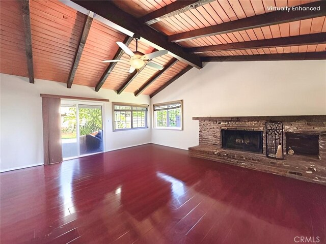 unfurnished living room with lofted ceiling with beams, a fireplace, a ceiling fan, wood finished floors, and wood ceiling