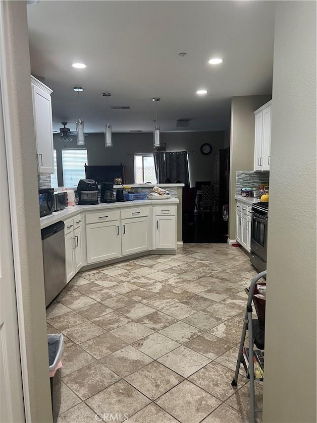 36316 Grazia Way, Winchester, CA 92596 - kitchen featuring gas range, tasteful backsplash, dishwasher, a peninsula, and white cabinetry