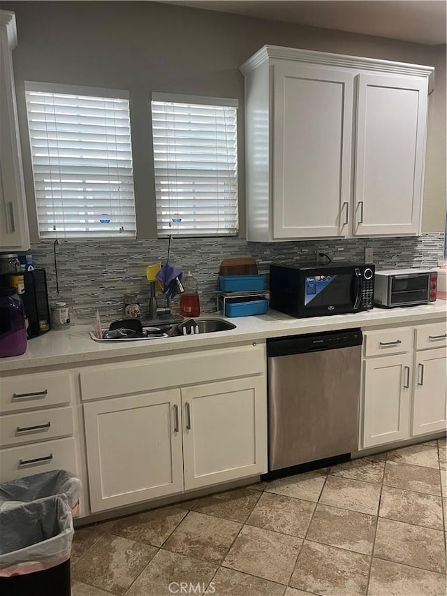 36316 Grazia Way, Winchester, CA 92596 - kitchen with stainless steel dishwasher, black microwave, light countertops, white cabinetry, and backsplash
