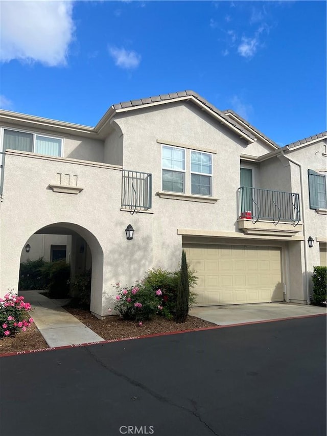 36316 Grazia Way, Winchester, CA 92596 - mediterranean / spanish-style house with a garage, stucco siding, concrete driveway, and a balcony