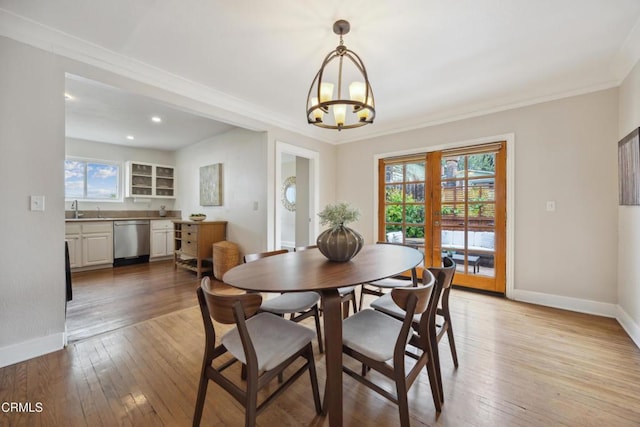 dining space featuring a healthy amount of sunlight, baseboards, and a chandelier