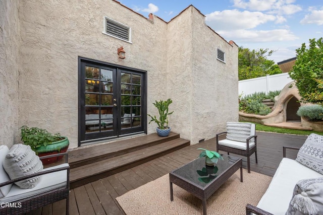 deck featuring fence, french doors, and an outdoor hangout area