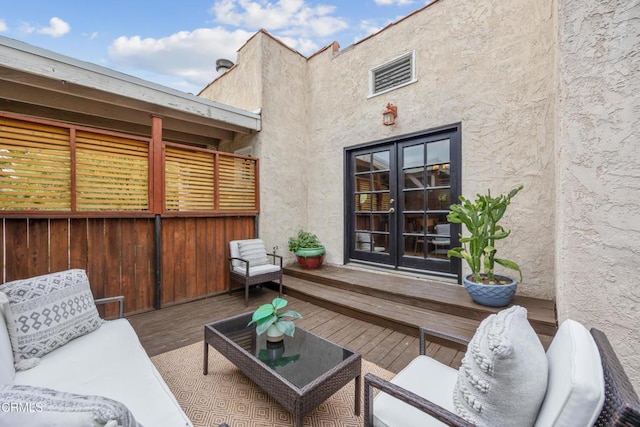 view of patio / terrace featuring french doors and a wooden deck