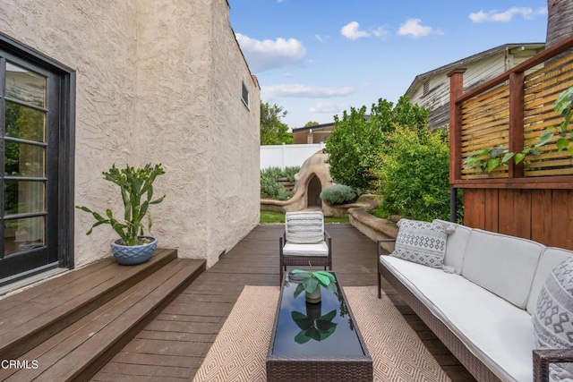 exterior space featuring a deck and outdoor lounge area
