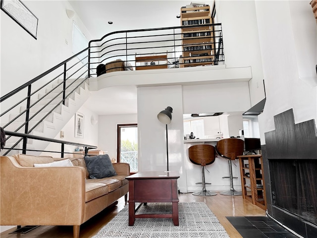 interior space with wood finished floors, a high ceiling, and stairway