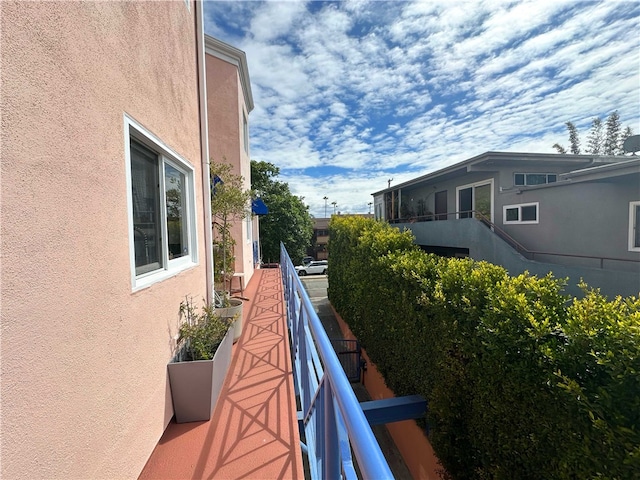 view of home's exterior with a balcony and stucco siding