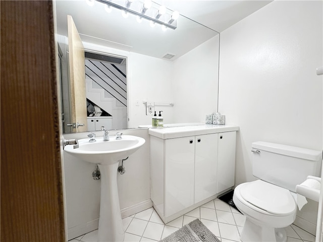 half bath featuring tile patterned floors, toilet, and visible vents
