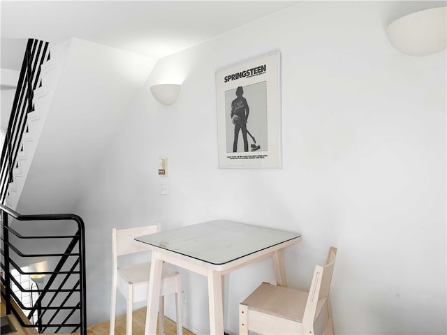 dining space featuring stairway