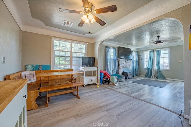 2415 E Childs Ave, Merced, CA 95341 - interior space with ceiling fan, light wood finished floors, a raised ceiling, a textured ceiling, and visible vents