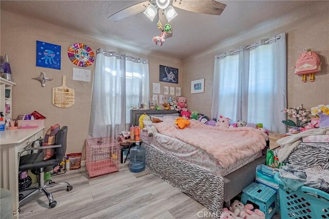 2415 E Childs Ave, Merced, CA 95341 - bedroom with a textured wall, ceiling fan, and wood finished floors