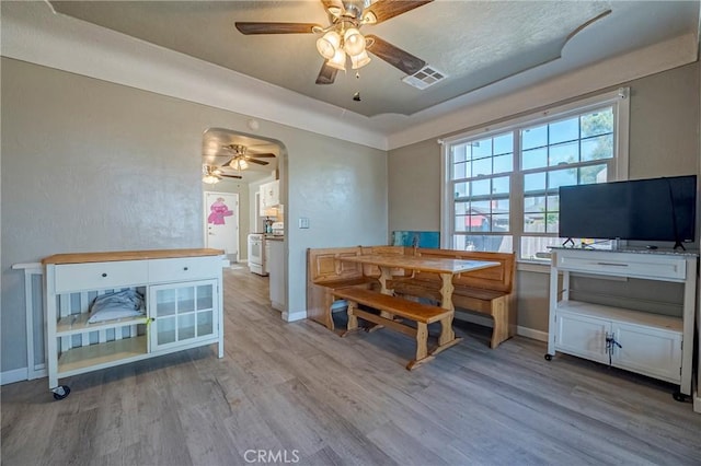 2415 E Childs Ave, Merced, CA 95341 - dining space with baseboards, a ceiling fan, arched walkways, and wood finished floors