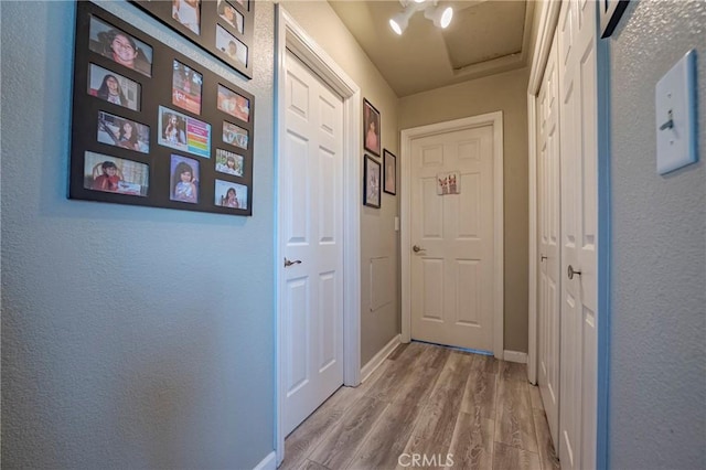 2415 E Childs Ave, Merced, CA 95341 - entryway with baseboards, a textured wall, and wood finished floors