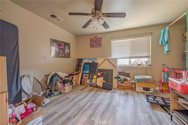 2415 E Childs Ave, Merced, CA 95341 - playroom featuring a ceiling fan, wood finished floors, and visible vents