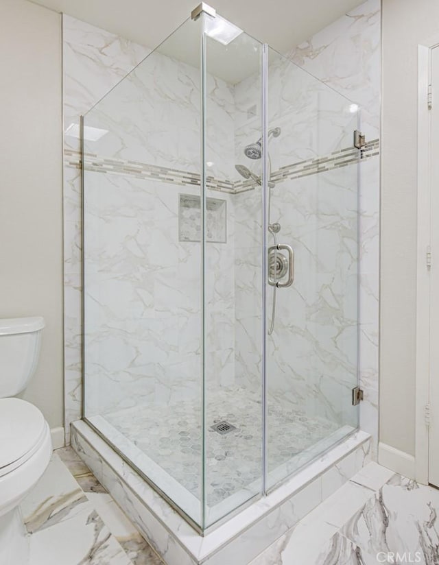 full bath with a marble finish shower, baseboards, toilet, and marble finish floor