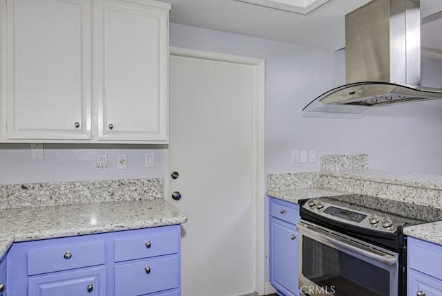kitchen featuring white cabinets, stainless steel range with electric cooktop, island range hood, and blue cabinets