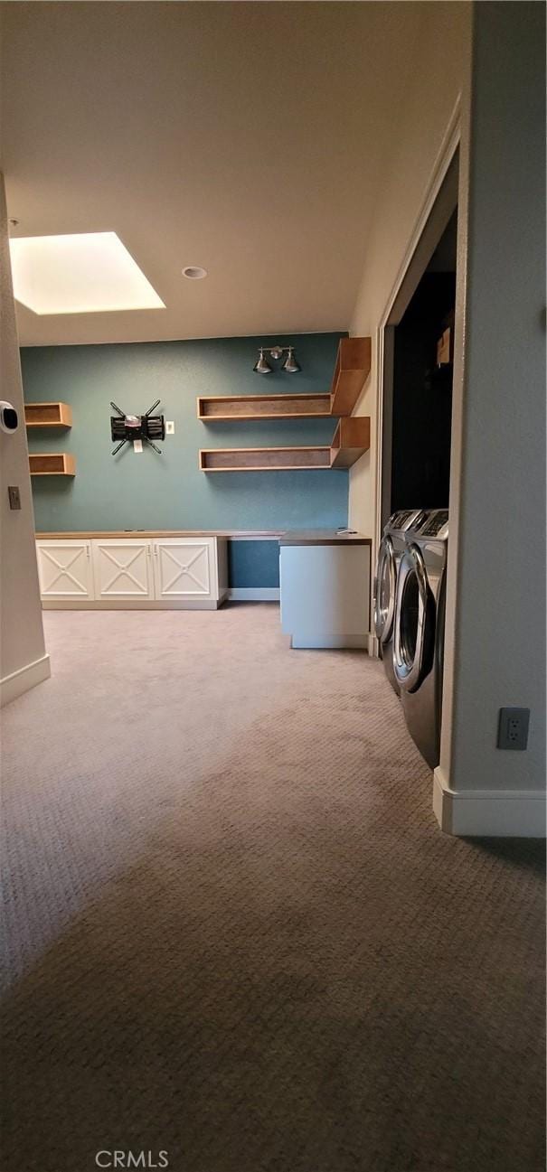 hallway with carpet floors, baseboards, and washing machine and clothes dryer