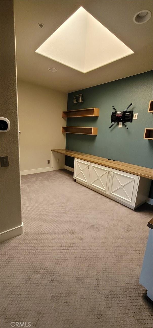 interior space featuring baseboards and carpet flooring