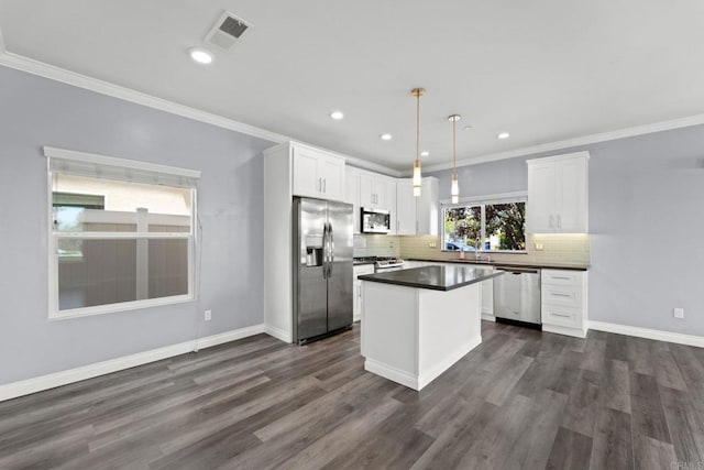 kitchen featuring visible vents, dark countertops, white cabinetry, appliances with stainless steel finishes, and backsplash