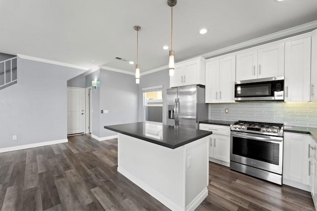 kitchen with visible vents, ornamental molding, appliances with stainless steel finishes, and dark countertops