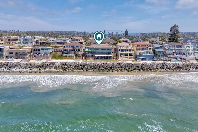 birds eye view of property with a water view and a view of the beach