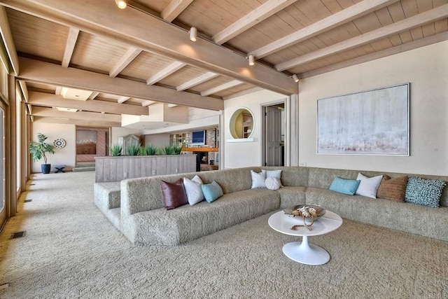 carpeted living room featuring visible vents, beam ceiling, and wooden ceiling