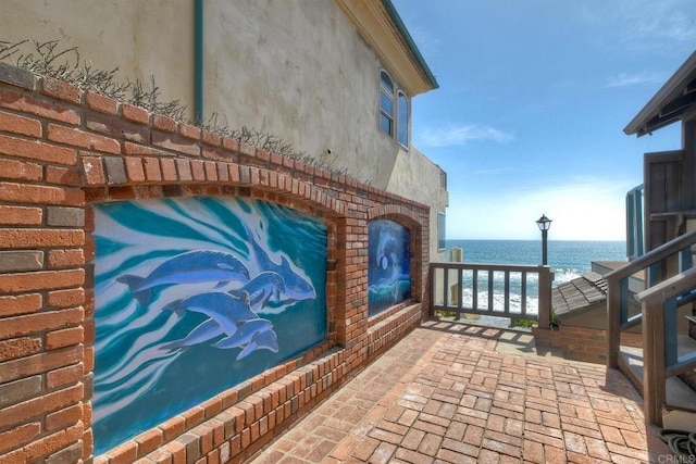 view of patio with a water view