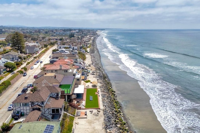 birds eye view of property featuring a water view, a view of the beach, and a residential view