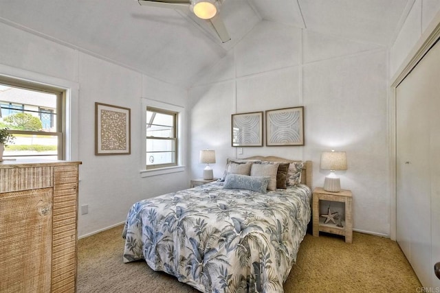 bedroom featuring vaulted ceiling, multiple windows, a ceiling fan, and carpet flooring