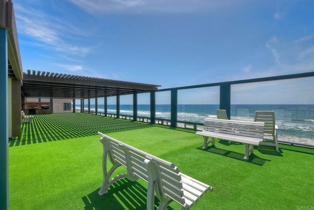 view of yard featuring a water view and a view of the beach