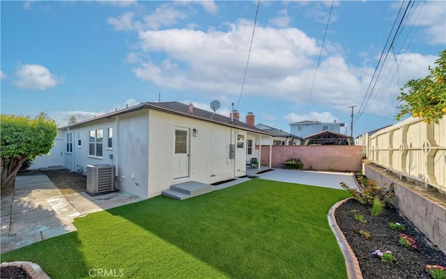 back of house with a lawn, a patio, cooling unit, and a fenced backyard