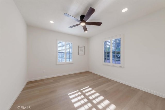 unfurnished room with baseboards, a ceiling fan, recessed lighting, and light wood-style flooring