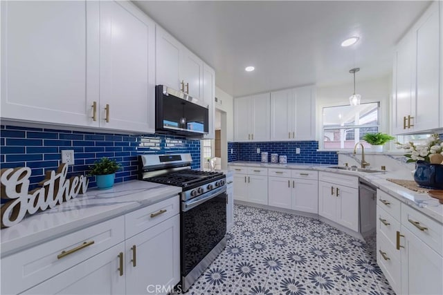 kitchen with white cabinets, stainless steel appliances, decorative backsplash, and a sink