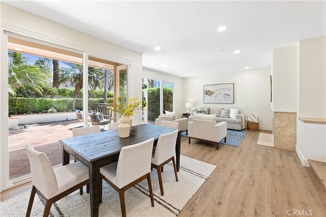 dining room with light wood-style floors, baseboards, and recessed lighting