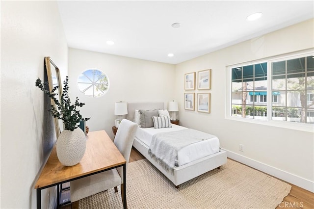bedroom with light wood-style floors, recessed lighting, baseboards, and multiple windows