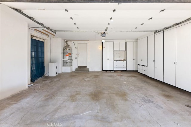 garage featuring secured water heater and a garage door opener