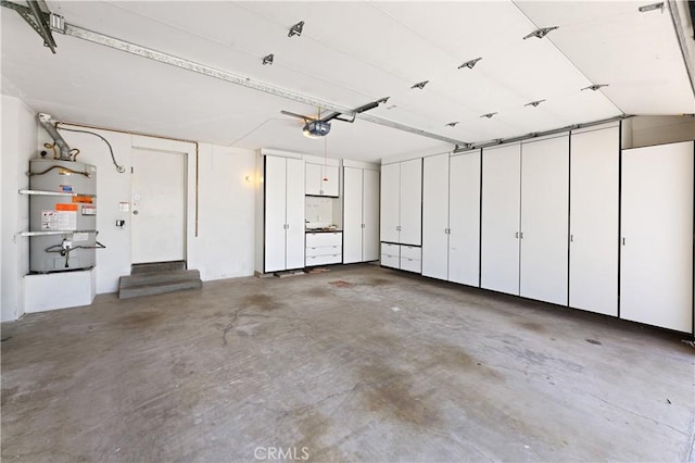 garage with secured water heater and a garage door opener
