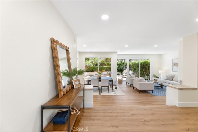 living room featuring light wood finished floors and recessed lighting