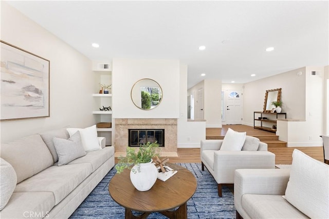 living area featuring baseboards, recessed lighting, light wood-style flooring, and visible vents