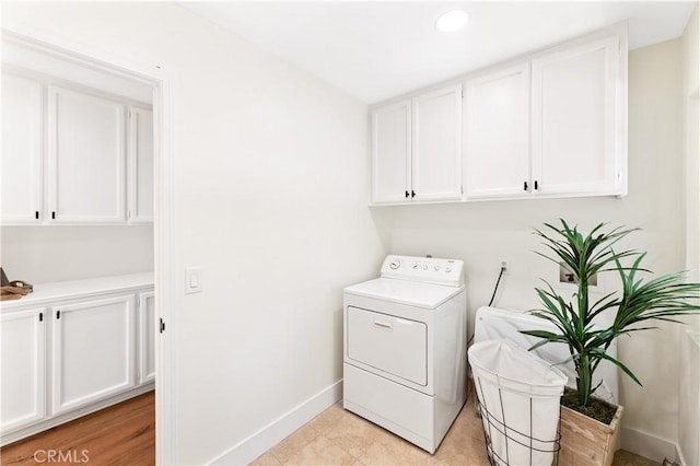 laundry area with cabinet space, recessed lighting, baseboards, and washer / dryer