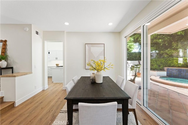 dining room featuring baseboards, recessed lighting, light wood finished floors, and visible vents