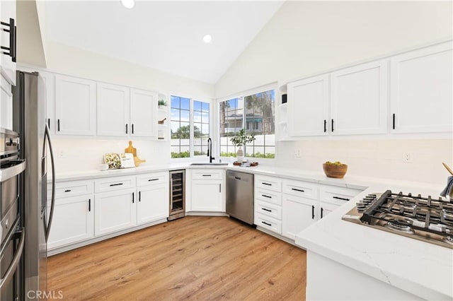 kitchen with open shelves, a sink, beverage cooler, stainless steel appliances, and recessed lighting
