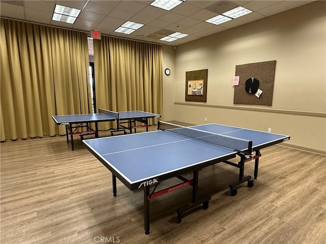 rec room with wood finished floors, baseboards, and a drop ceiling