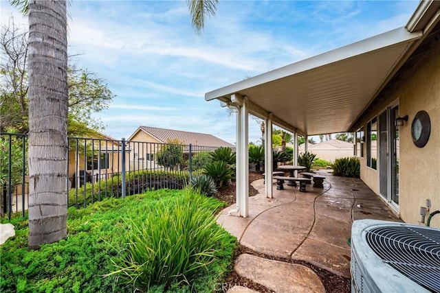 view of patio / terrace featuring central AC and fence