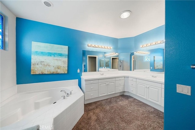 bathroom with a sink, a garden tub, an enclosed shower, and double vanity