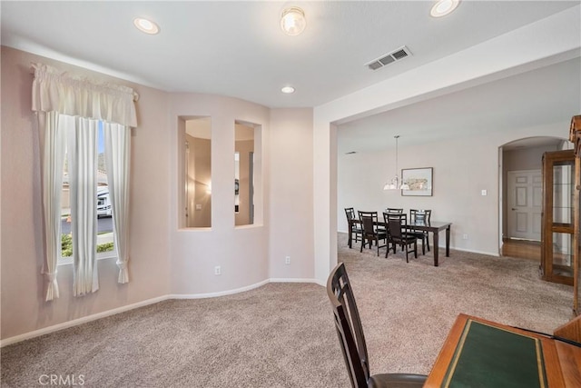 interior space featuring arched walkways, baseboards, recessed lighting, and visible vents