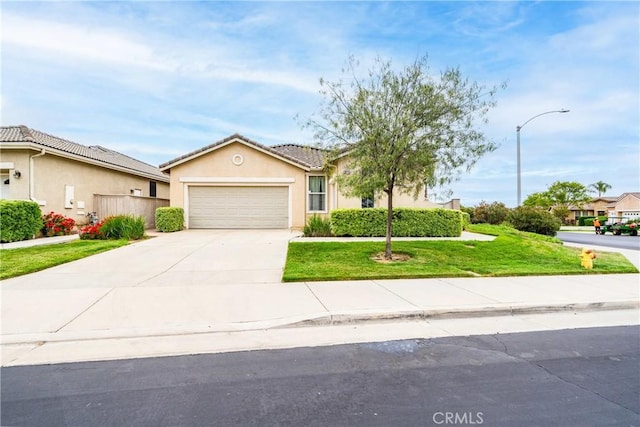 ranch-style house featuring driveway, a tile roof, a front lawn, an attached garage, and stucco siding