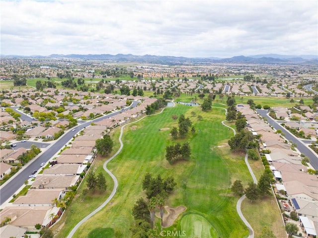 birds eye view of property with view of golf course, a mountain view, and a residential view