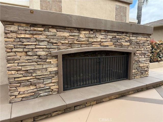 details featuring an outdoor stone fireplace