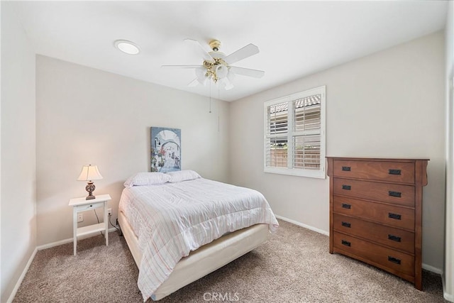 bedroom featuring baseboards, ceiling fan, and light carpet