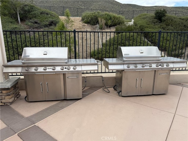 view of patio featuring fence and grilling area